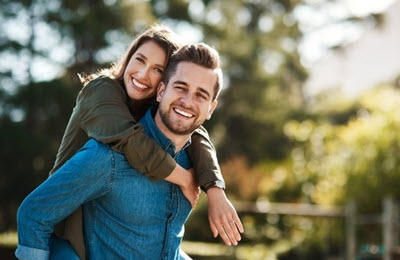 Young couple smiling while enjoying being outdoors